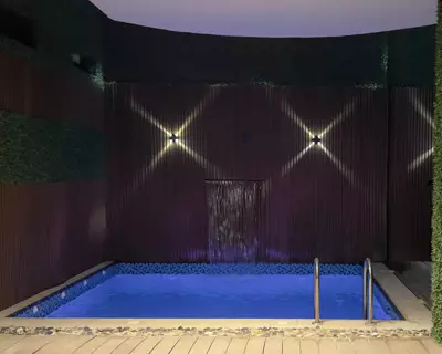 Pool at night — Timber-Detailed Villa, Al Mohammadiyah