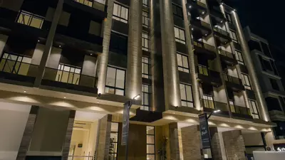 Façade at night — Kayan Residence, Al Nahda