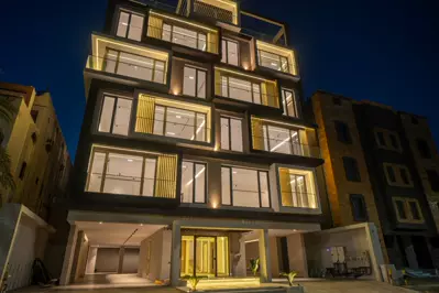 Façade at night — Al Zahra Residences